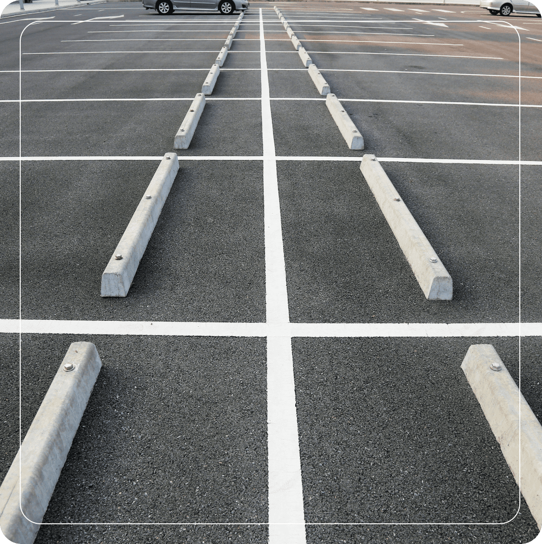 Empty parking lot with concrete barriers.