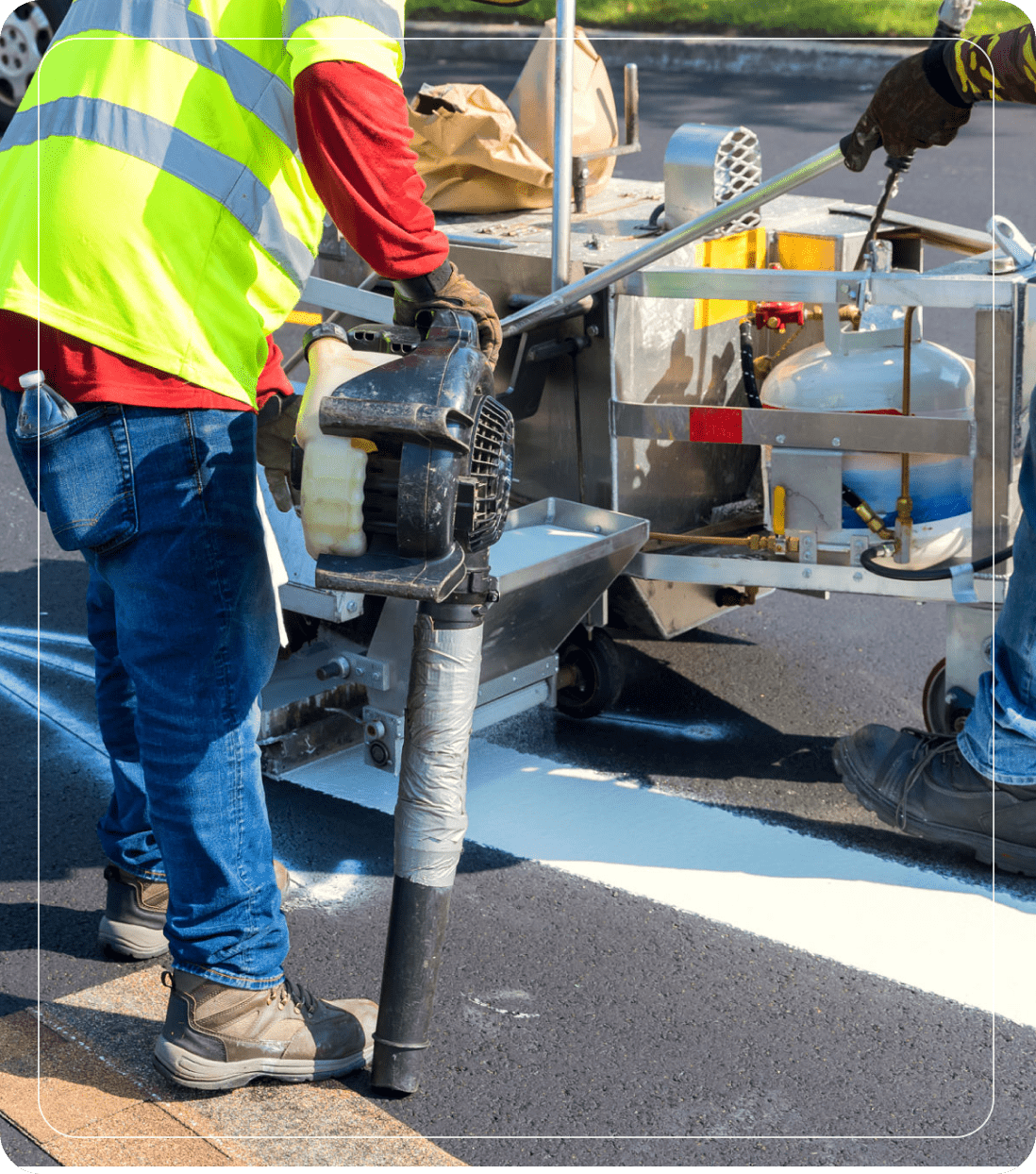 Road construction workers painting street lines.